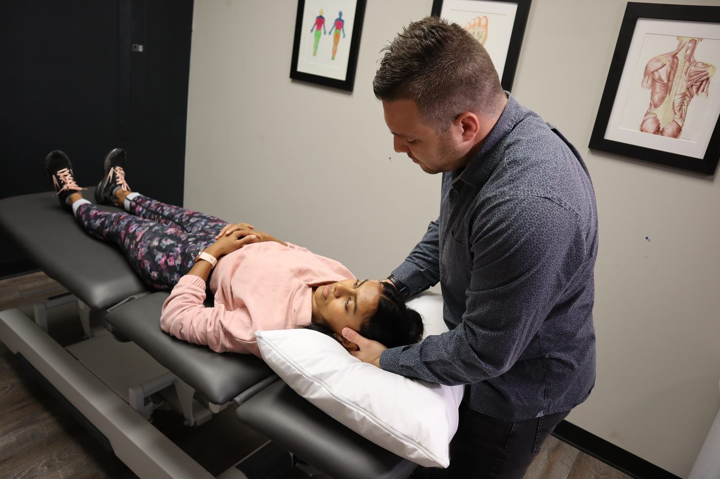 Ethan Brinkmann, PT, DPT, RMSK, performing hands-on physical therapy at ENIGMA in Mankato